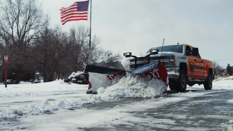Western Landscape plow truck clearing snow from a Madison, WI street.