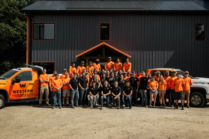 Western Landscape team outside their Madison, WI shop with company trucks.